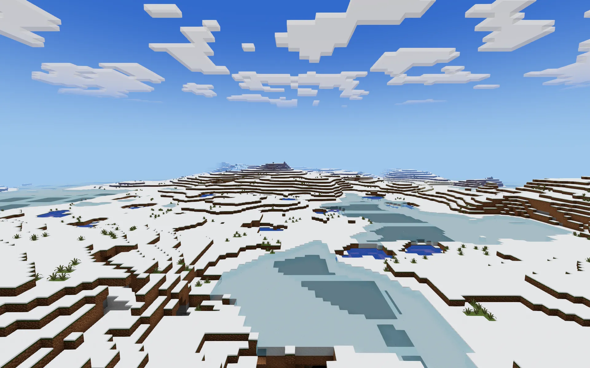 Snow-covered hills around a frozen lake of pale blue ice, with small pools of open water.